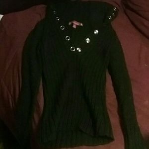 A long sleeved black button up sweater